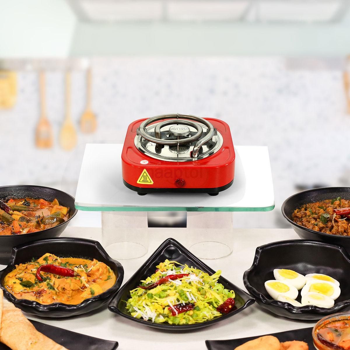 Red hot plate with food items on a white surface